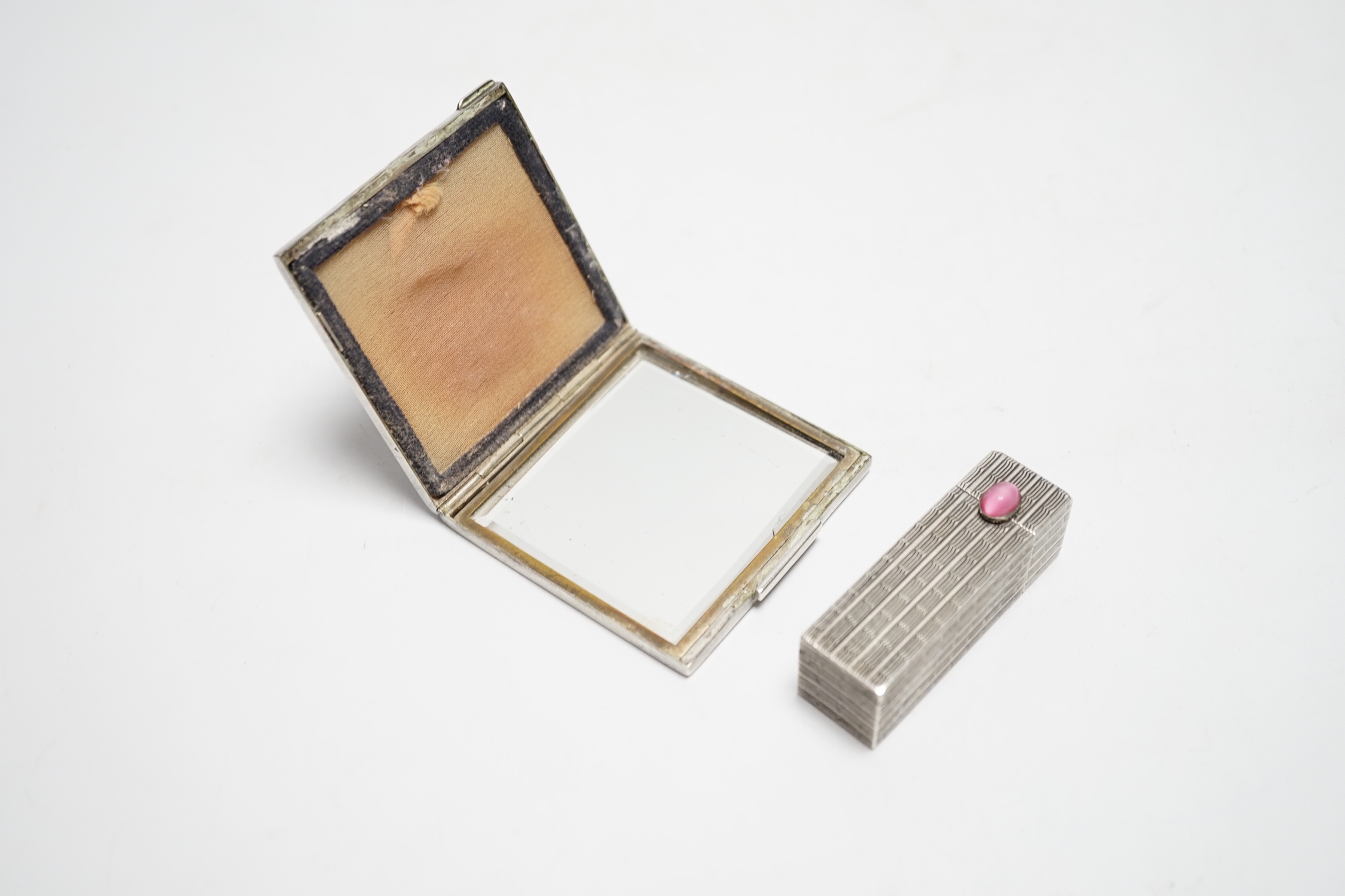 A mid century white metal compact and lipstick holder with cabochon pink stone clasp, largest 6cm wide